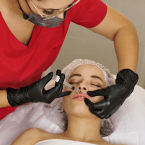 Cosmetic doctor administering lip injections to enhance the contour, definition and shape of a patients lips